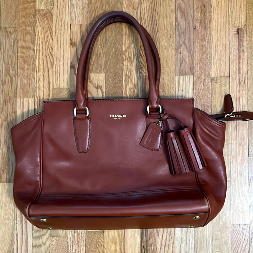 Coach brown leather purse. Tassels on handle.